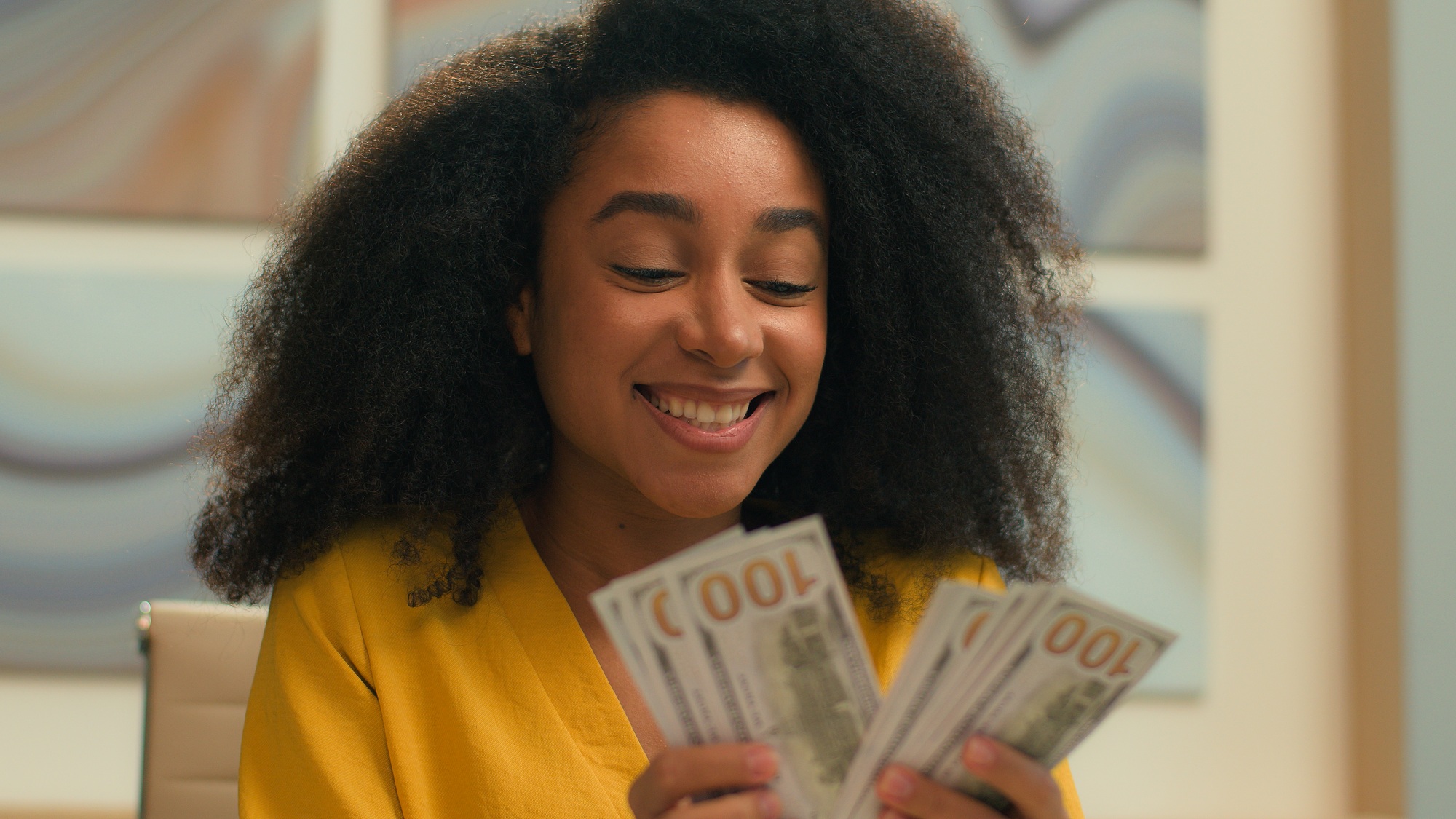 Happy joyful African American business woman rich successful businesswoman entrepreneur counting